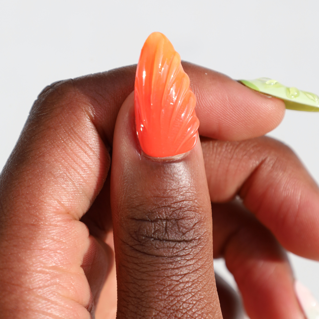 Dark skinned thumb with Fruit Chunk 3D Nails