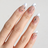Angled photo of light skinned hand with Chrome Celestial French Tip Nails