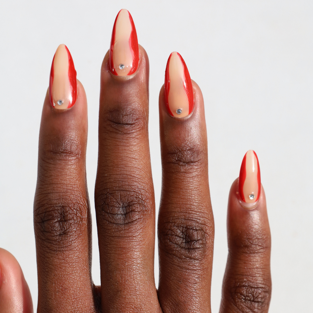 Dark skinned hand with Red Accent with Gems Nails