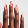 Dark skinned hand with Red Accent with Gems Nails