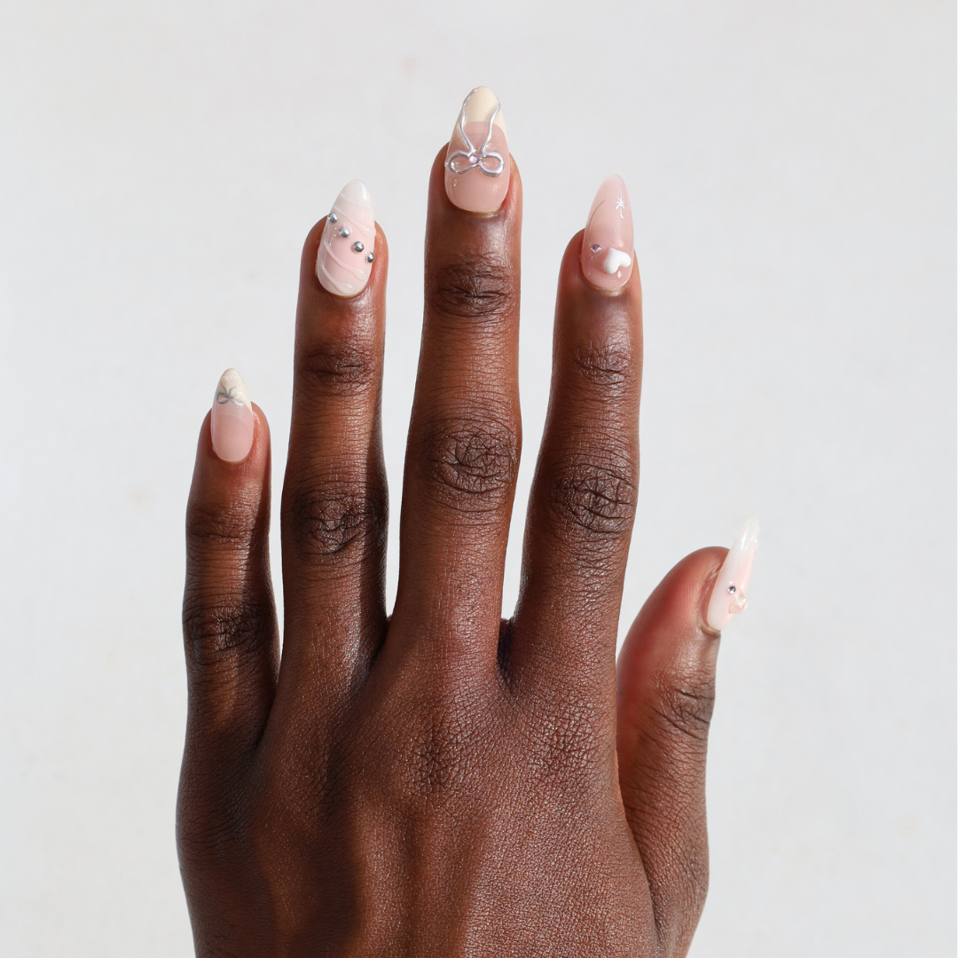 Dark skinned hand with Bow and Charms Chrome Nails