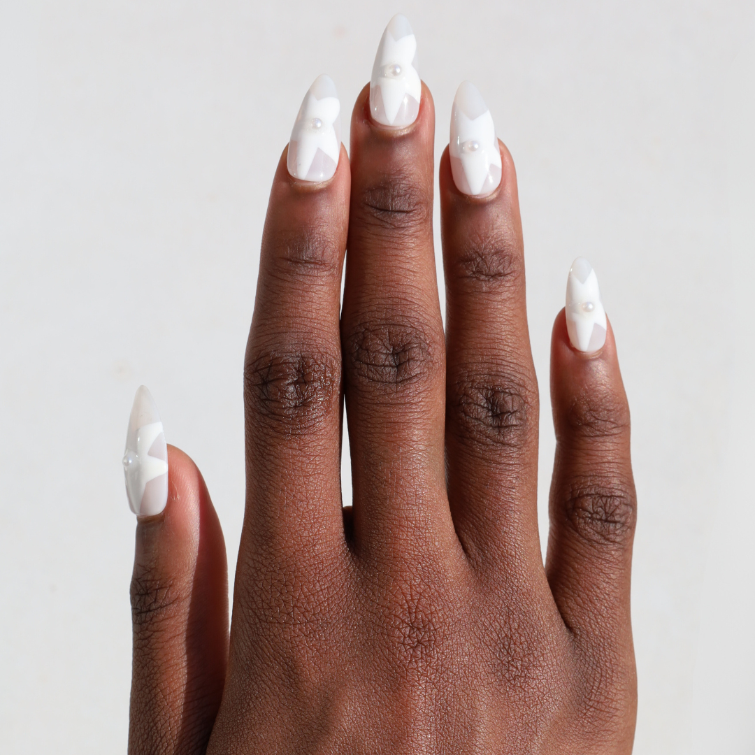Dark skinned hand with Winter White Star Pearl Nails