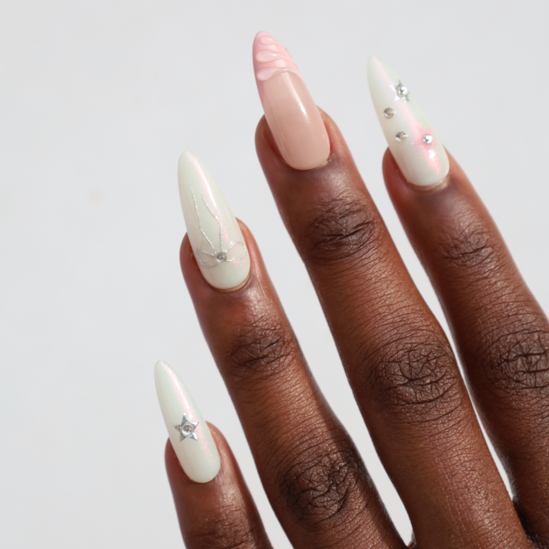 Dark skinned hand with Pastel Glazed 3D Bow Nails