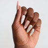 Dark skinned hand with Pastel Glazed 3D Bow Nails