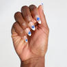 Dark skinned hand with Blue Star French Tips