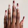 Dark skinned hand with Cherry 3D Bow Coffin Nails