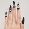 Light skinned hand with Black Cateye Gem Nails