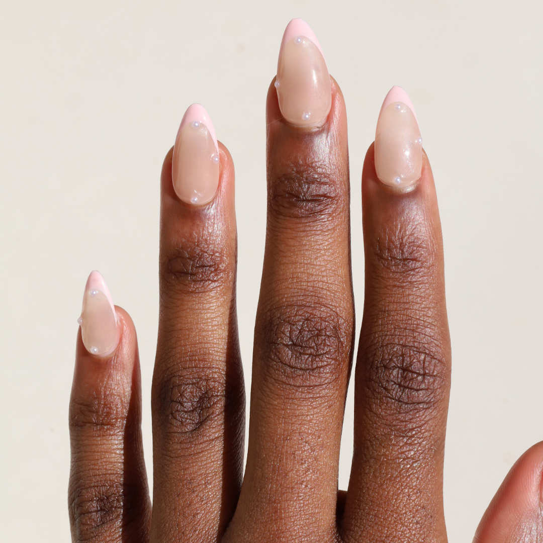 Dark skinned hand with Pearl Nude French Tip Nails