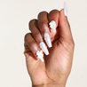 Dark skinned hand with White Chrome 3D Bow Pearl Nails