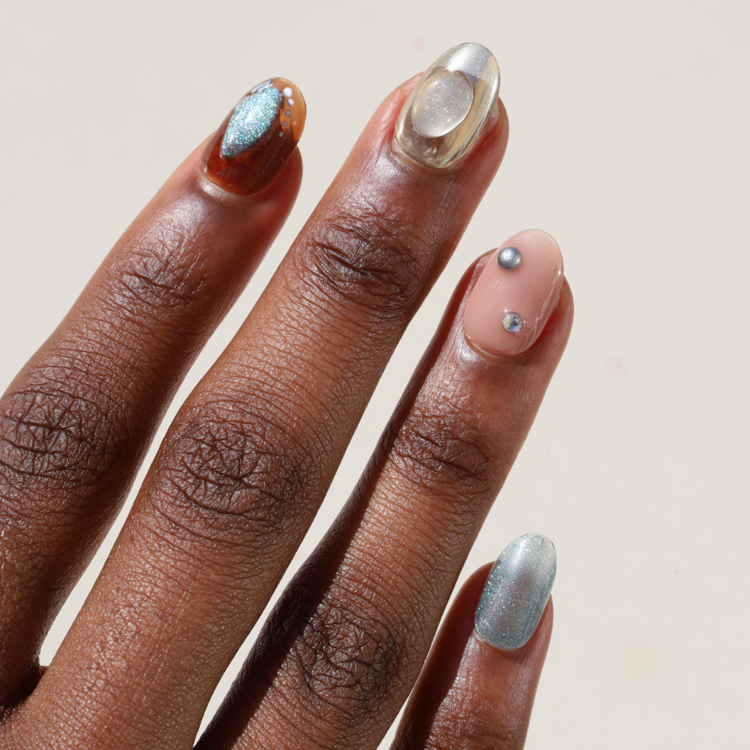 Angled photo of dark skinned hand with Bubble 3D Metallic Nails