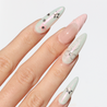Angled photo of light skinned hand with Pastel Glazed 3D Bow Nails