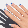 Angled photo of light skinned hand with Blue Star French Tips