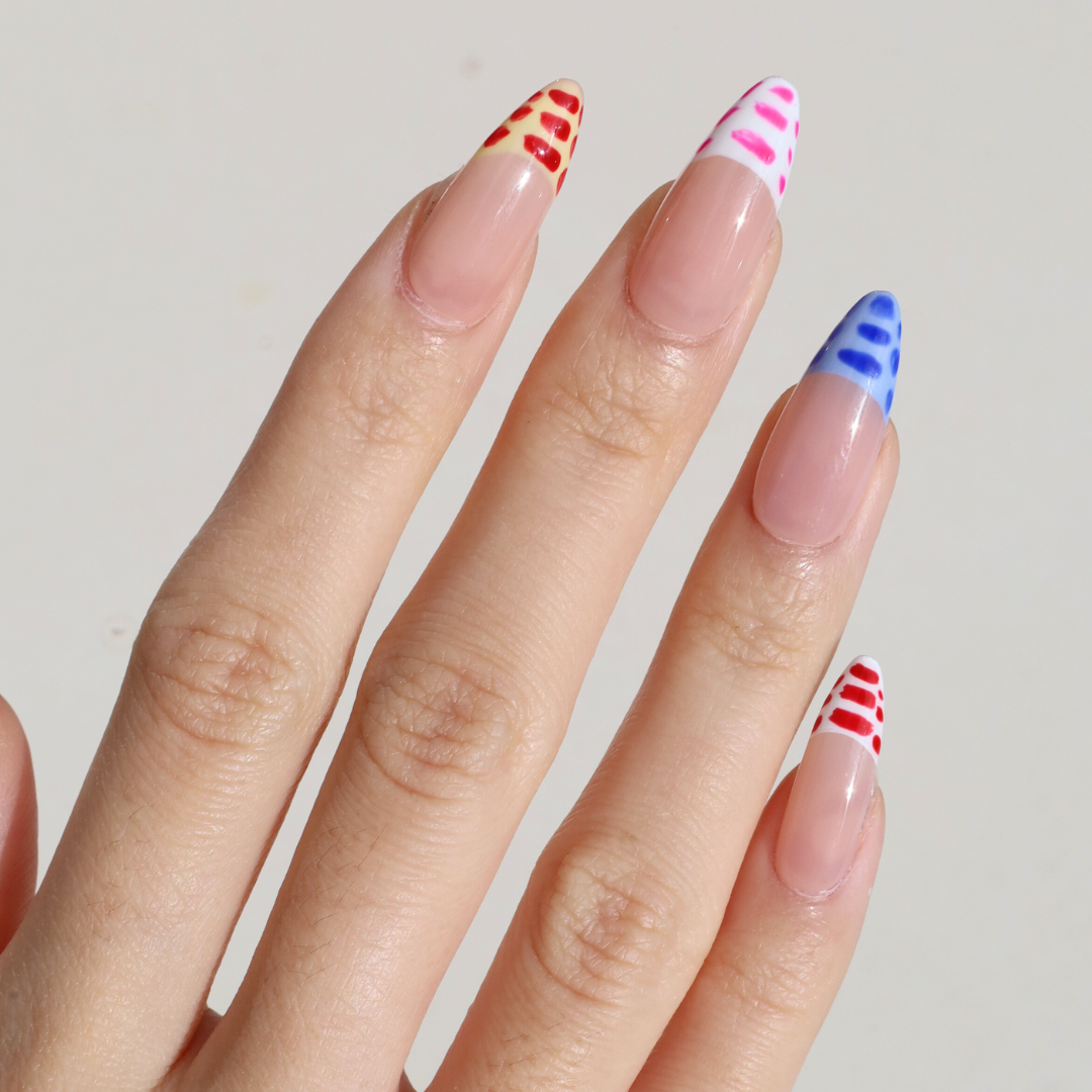 Angled photo of light skinned hand with Crocodile French Tips