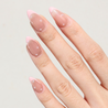 Angled photo of light skinned hand with Pearl Nude French Tip Nails