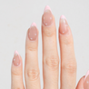Light skinned hand with Pearl Nude French Tip Nails