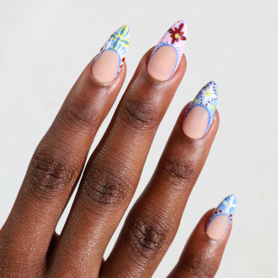 Angled photo of dark skinned hand with Colorful Mediterranean Porcelain Nails