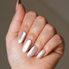 Light skinned hand with pink cat-eye nails