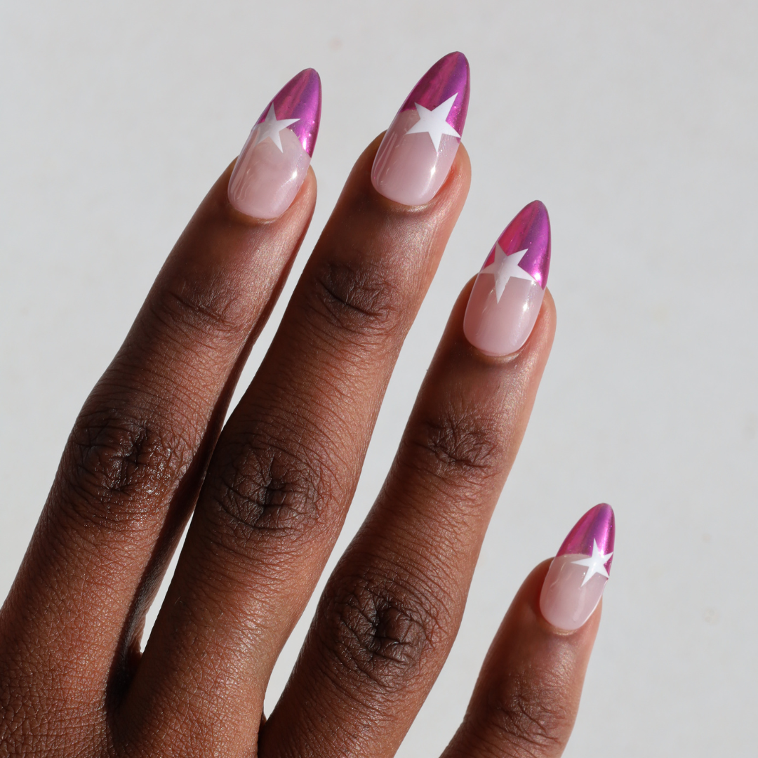 Angled photo of dark skinned hand with Pink Star Chrome French Tips