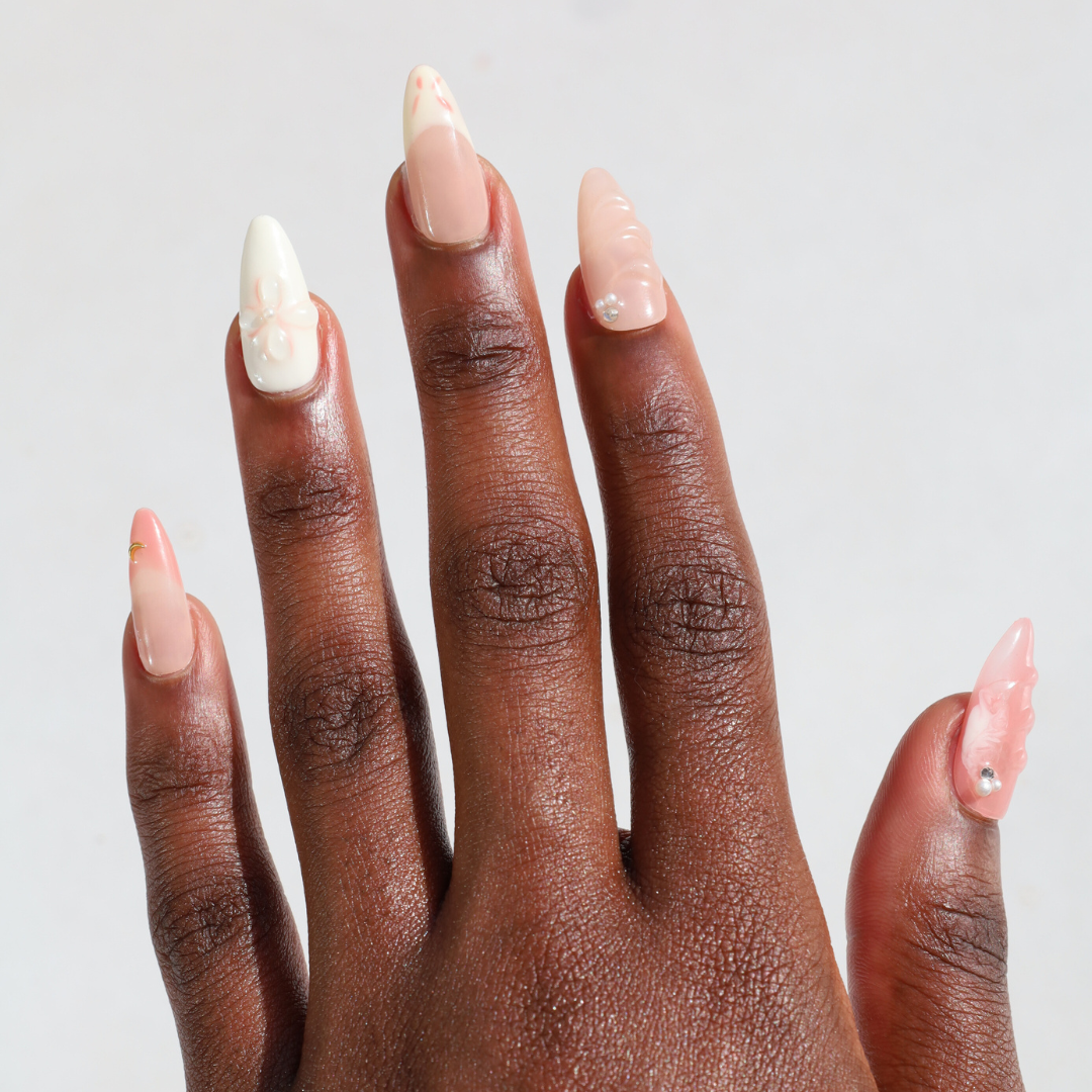 Dark skinned hand with Orchid 3D Nails