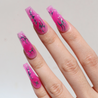 Angled photo of light skinned hand with Chrome Pink Coffin Nails
