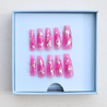 Dark skinned hand with Chrome Pink Coffin Nails on packaging