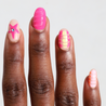 Dark skinned hand with Neon 3D Pink Orange Nails