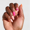 Dark skinned hand with Neon 3D Pink Orange Nails