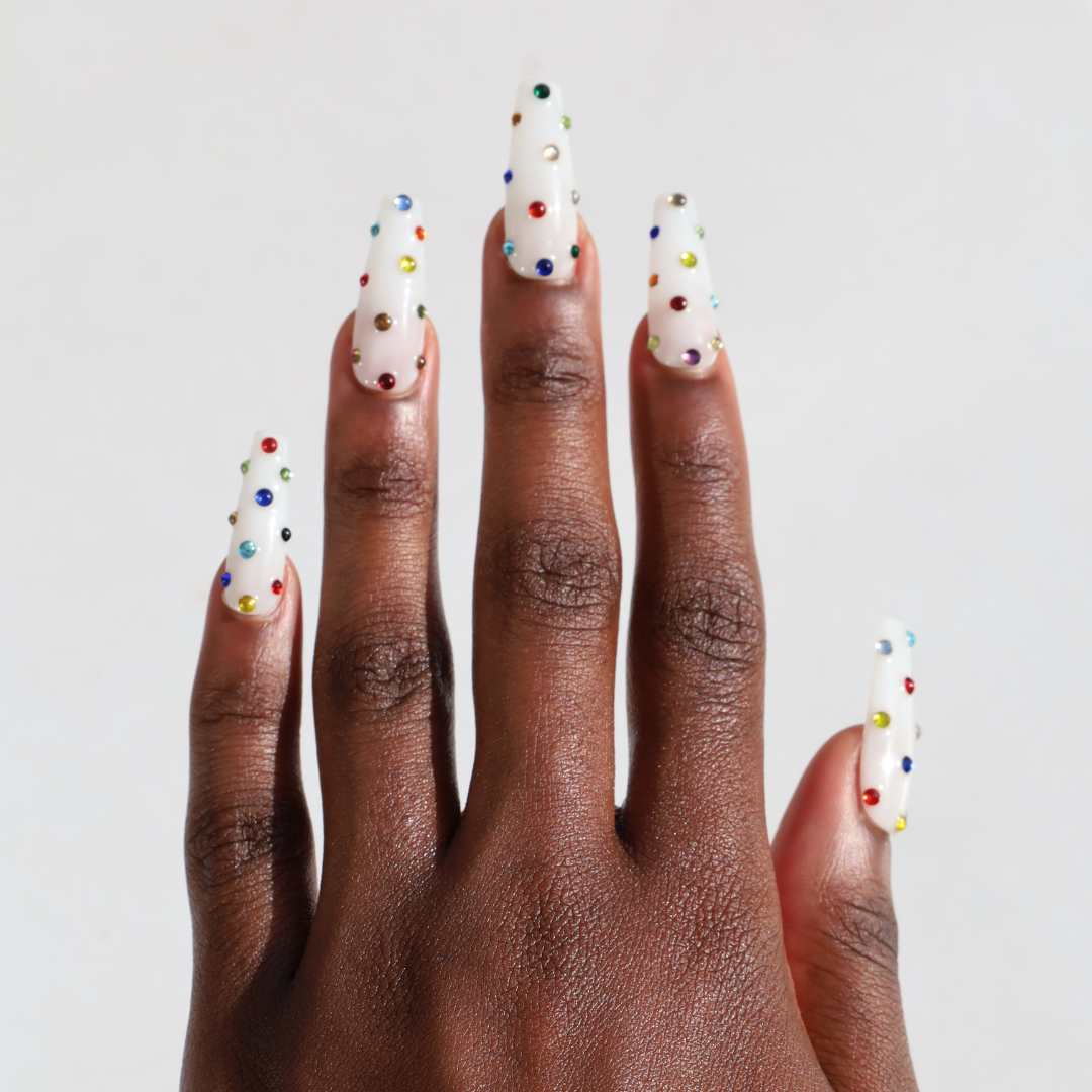 Dark skinned hand with Rainbow Gems Coffin Nails