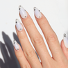 Angled photo of light skinned hand with Celestial Blue Aura Nails