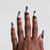 Dark skinned hand with Black Cateye Gem Nails