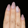 Light skinned hand with pink cat-eye nails