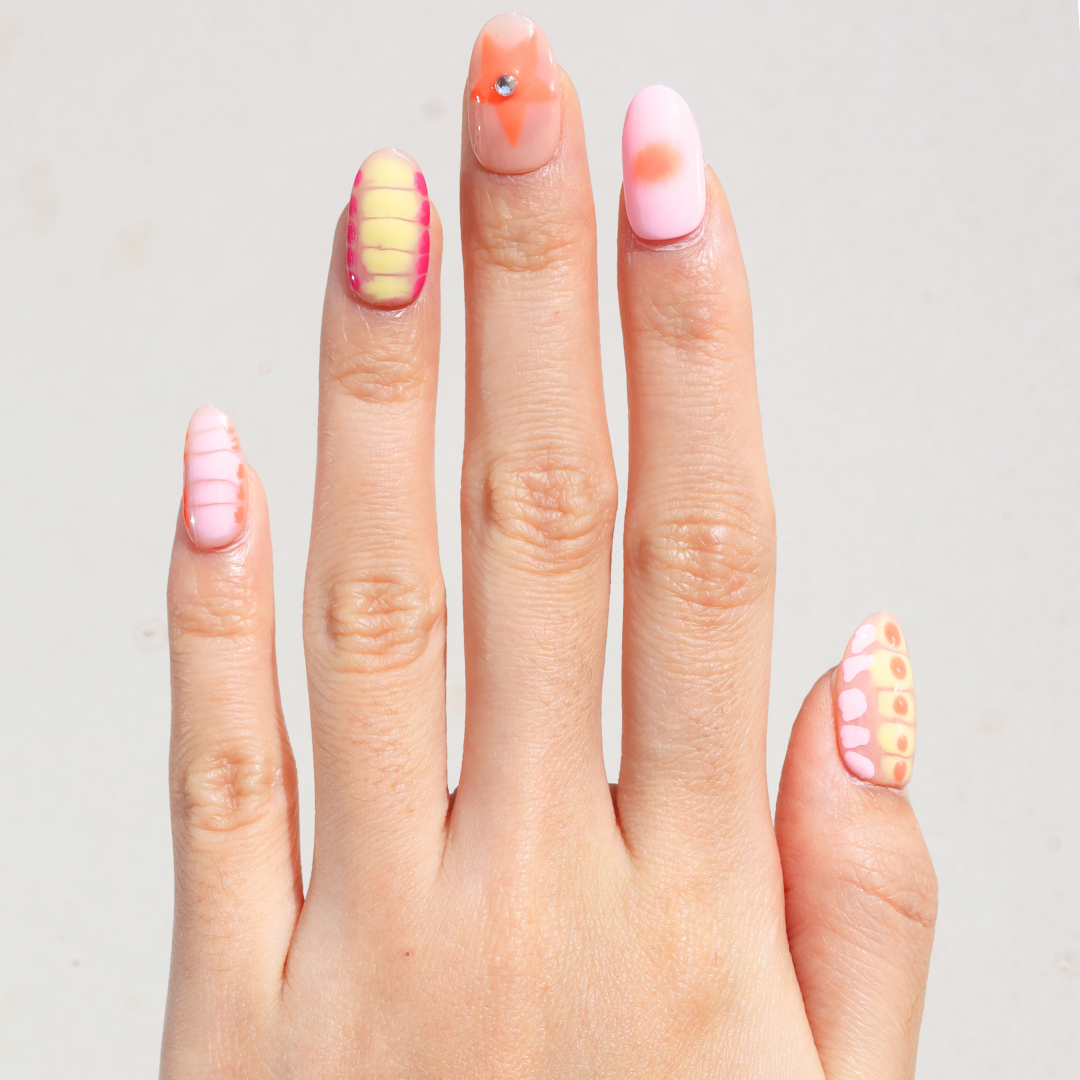 Light skinned hand with Neon 3D Pink Orange Nails
