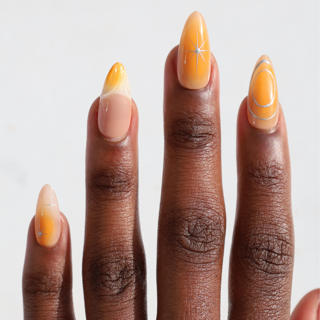Dark skinned hand with Orange Chrome Moderne Nails