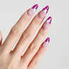 Angled photo of light skinned hand with Pink Star Chrome French Tips