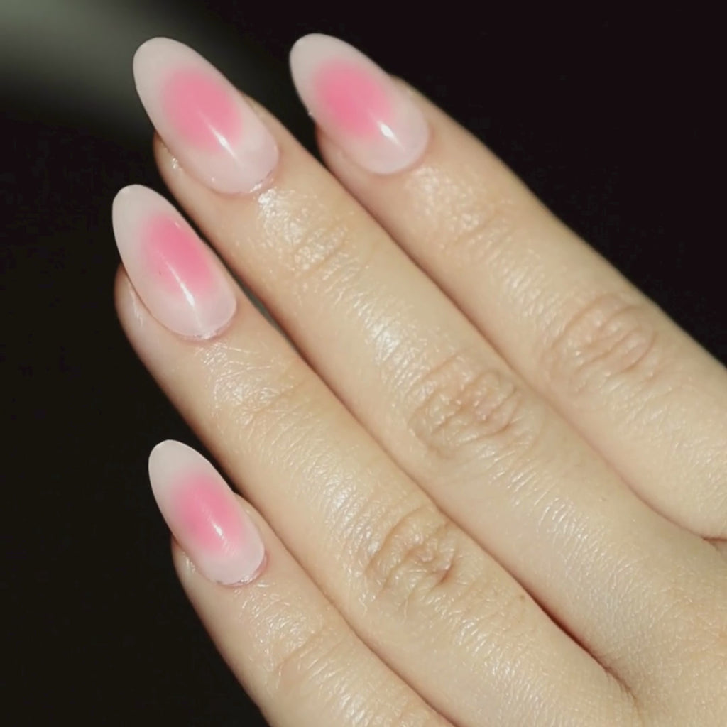 Video of light skinned hand with light and dark pink aura nails