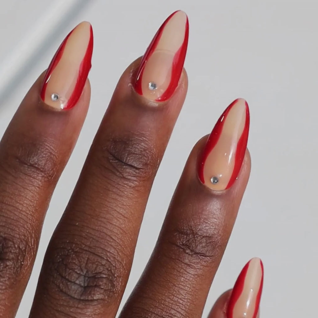 Video of dark skinned hand with Red Accent with Gems Nails