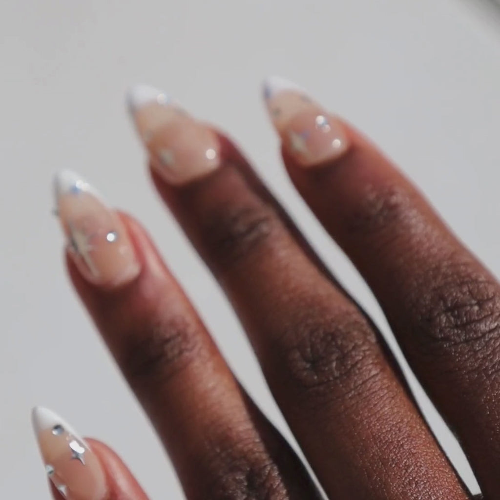 Video of dark skinned hand with Chrome Celestial French Tip Nails