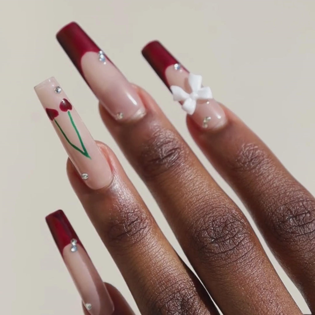 Video of dark skinned hand with Cherry 3D Bow Coffin Nails