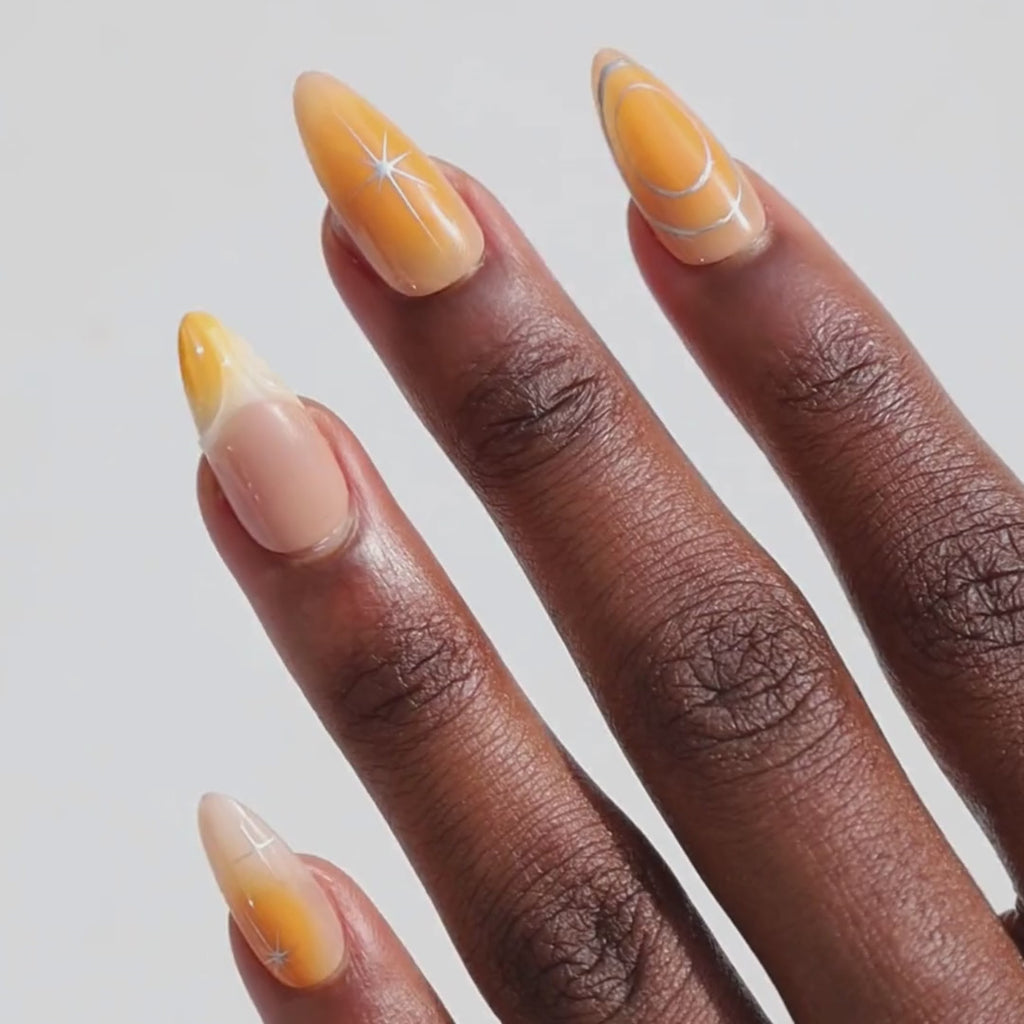 Video of dark skinned hand with Orange Chrome Moderne Nails